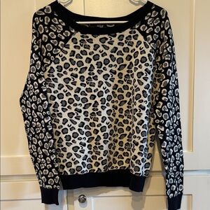 Women’s SZ medium, black and white animal print sweater. Ads flare to an outfit.